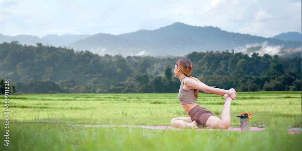 Healthy women doing yoga in the morning In the middle of a rice field . concept healthy and outdoor activity