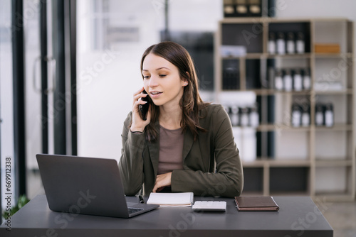 Caucasian businesswoman involved in cellphone call conversation giving professional consultation to client or negotiating project.