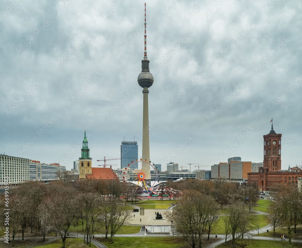 Obraz premium Berlin cityscape with a TV tower and St. Marien Church in winter.