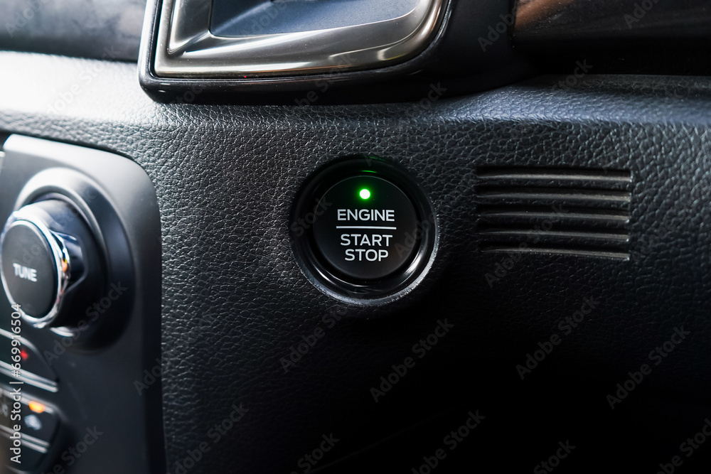 Close up engine car start button. Start stop engine modern new car button,Makes it easy to turn your auto mobile on and off. a key fob unique ,selective focus Close up engine car start button. Start stop engine modern new car button,Makes it easy to turn your auto mobile on and off. a key fob unique ,selective focus