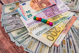 Small cube text SAVING on dollar euro bills background