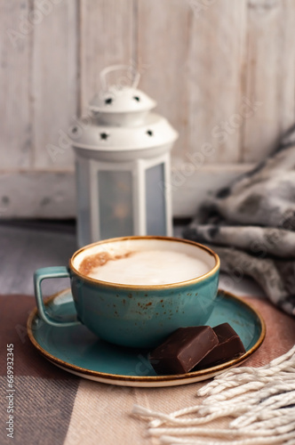 coffee mug , scarf and book on the table