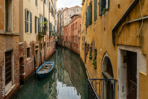 Channel in Venice - boat and old town houses © Dmitry Kovalchuk