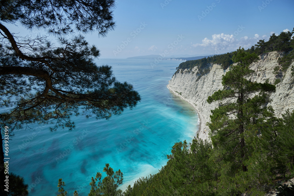 Blue azure sea against a background of white sheer cliffs. Seascape of coastline, beautiful nature, landscape. Tourism travel