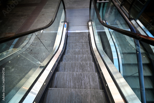 Top view of descending deserted escalator deliberated motion blur