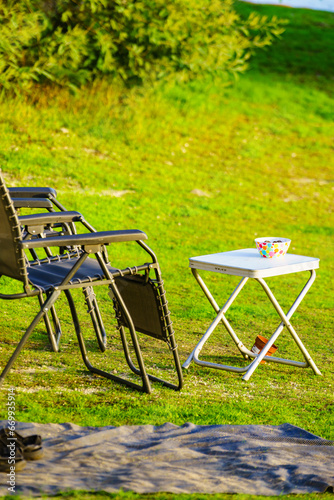 Empty camp chair and table on nature