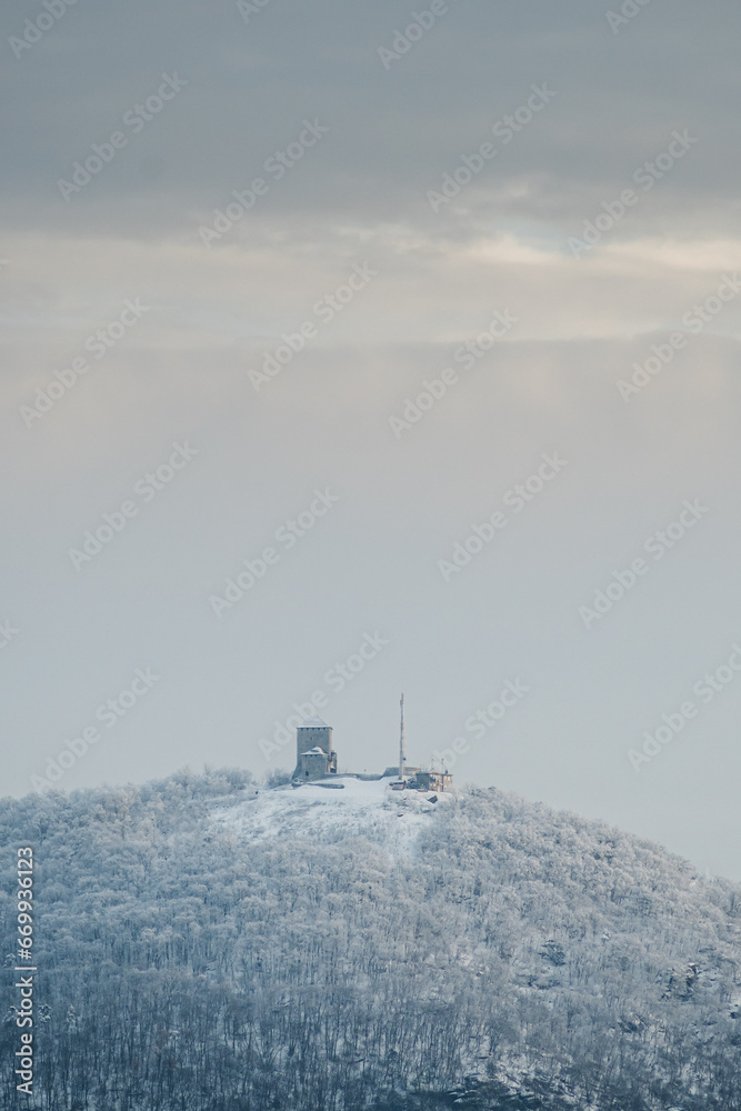 Medieval castle on top of a mountain in winter Medieval castle on top of a mountain in winter