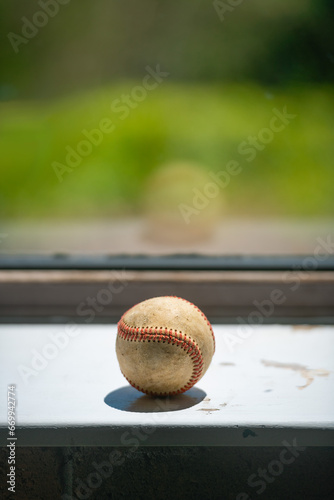 Old baseball ball on the windowsill, copy space.