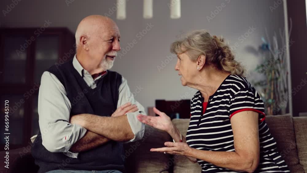 Elderly couple arguing while sitting on the sofa at home Elderly couple arguing while sitting on the sofa at home