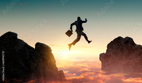 Businessman jump through the gap