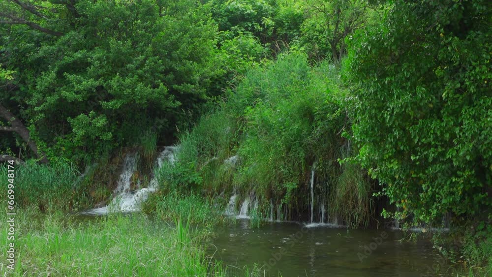 Small waterfall in the greenery of Krka National Park (Croatia) Small waterfall in the greenery of Krka National Park (Croatia)