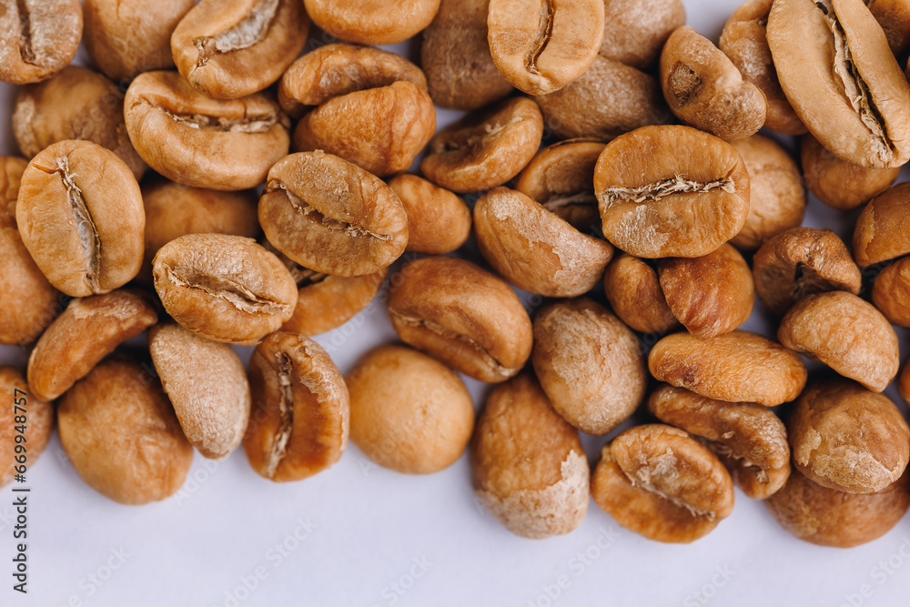 Macro fresh green raw roasting coffee beans, white isolated background Macro fresh green raw roasting coffee beans, white isolated background