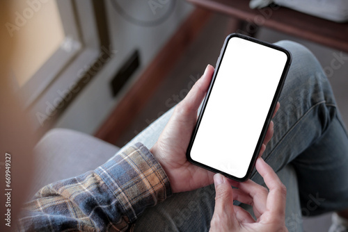 cell phone blank white screen mockup.hand holding texting using mobile on desk at office.background empty space for advertise.work people contact marketing business,technology