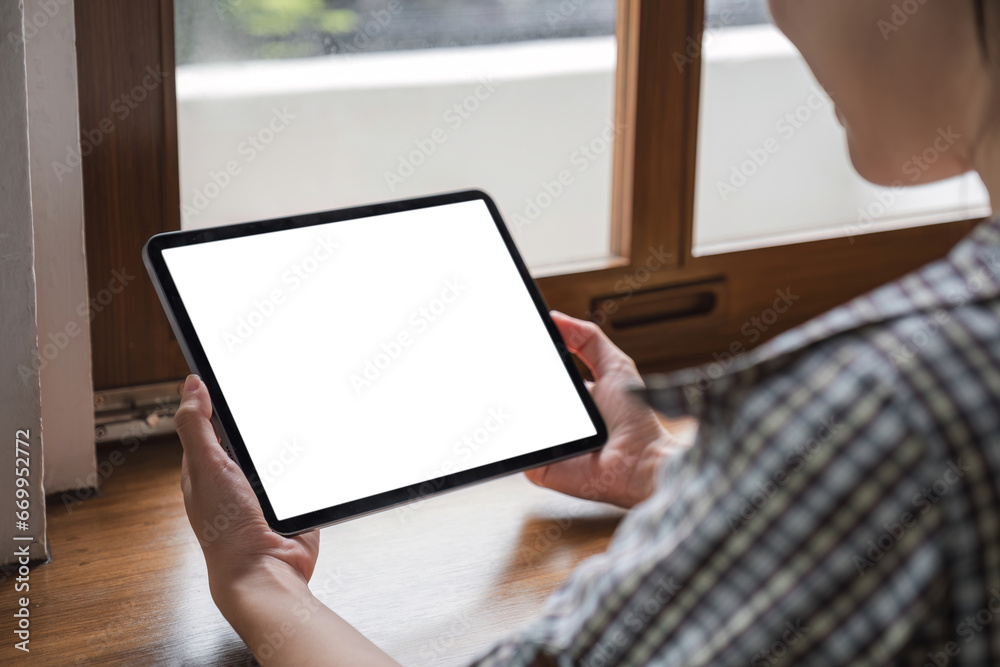 Mockup image of a woman holding digital tablet with blank white desktop screen Mockup image of a woman holding digital tablet with blank white desktop screen