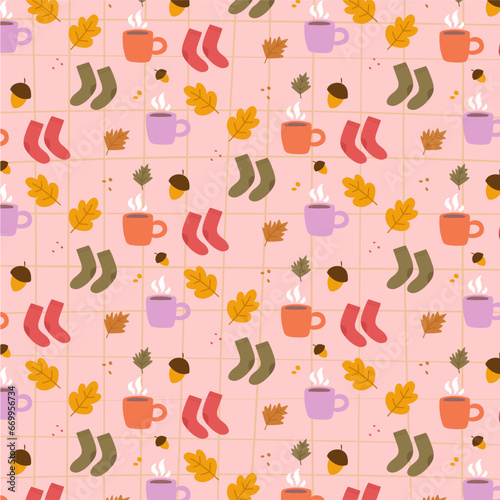 Autumn cozy seamless pattern with cocoa mug, socks, acorns and leaves on a pink checkered background