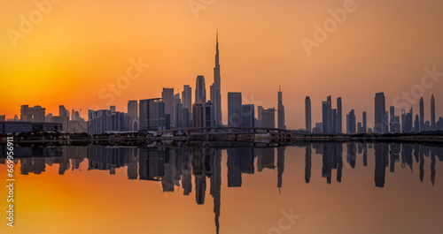 The urban skyline of Dubai Business bay with reflections of the modern skyscrapers in the water during sunset  UAE