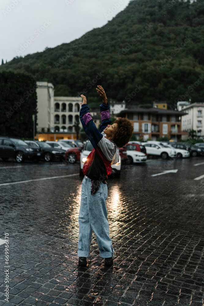Young woman enjoying and dancing in rain Young woman enjoying and dancing in rain