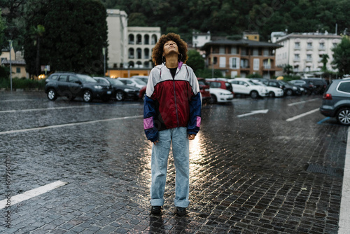 Woman with eyes closed standing in rain