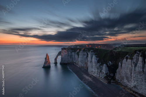 France, Normandy, Long exposure of Falaise dAval and Aiguille dEtretat rock formation at dawn photo