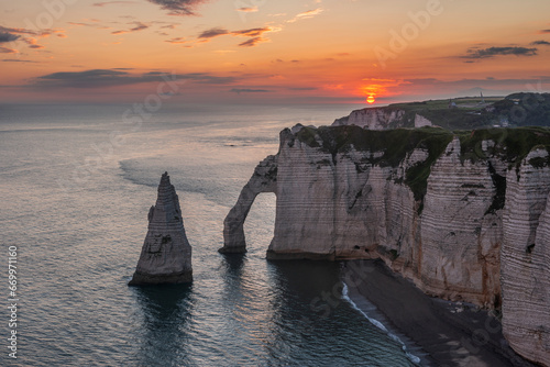 France, Normandy, Falaise dAval and Aiguille dEtretat rock formation at sunrise photo