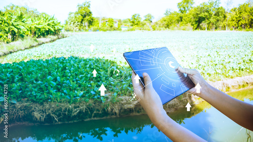 Close up hand holding tablet and open application smart farming.Agriculture green technology and science concept, ecology system.Hi-tech and futuristic.Digital and technology concept background.
