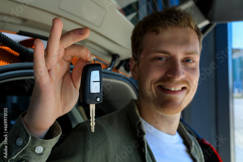 Close-up of the car key in the hands of a man. Buying a new car. Selective focus on key.