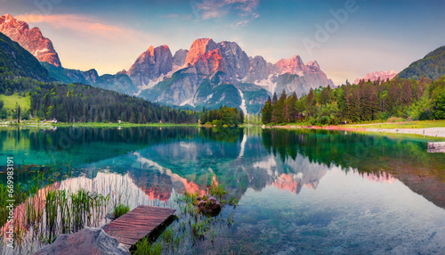 calm morning view of fusine lake colorful summer sunrise in julian alps with mangart peak on background province of udine italy europe beauty of nature concept background