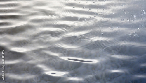 white water with ripples on the surface defocus blurred transparent white colored clear calm water surface texture with splashes and bubbles water waves with shining pattern texture background