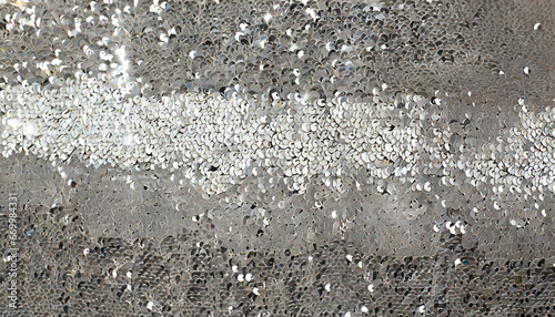 background of silver sequins and glare sparkling © Nichole