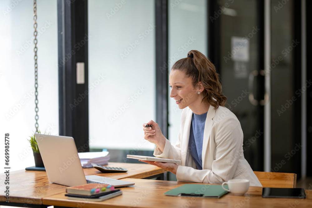 Businesswoman sitting in front of laptop considering work in the office Think about the work concept. Plan a new project Businesswoman sitting in front of laptop considering work in the office Think about the work concept. Plan a new project