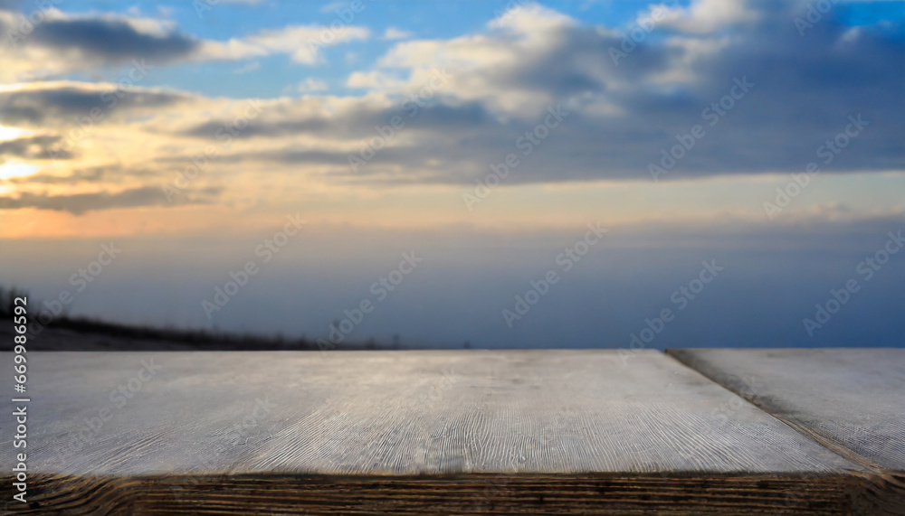 empty wooden table against the backdrop of a blurred blue sky sunrise background high quality photo
