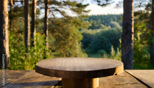 empty wooden round table for product placement or montage with blurred forest background high quality photo