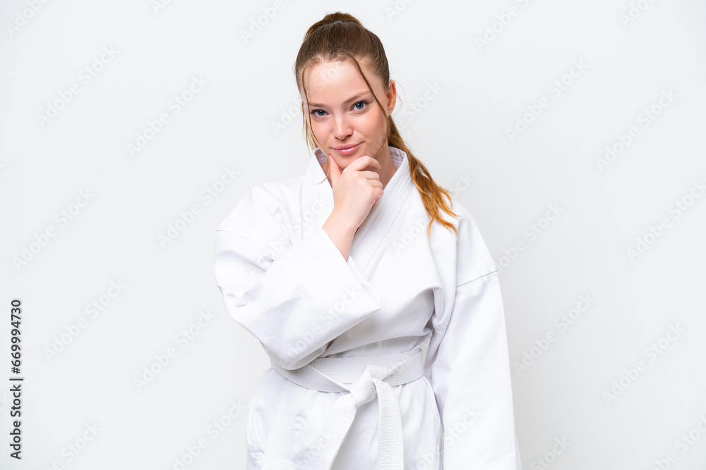 Young caucasian girl doing karate isolated on white background thinking Young caucasian girl doing karate isolated on white background thinking