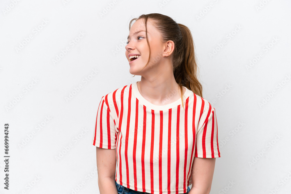 Young caucasian girl isolated on white background laughing in lateral position Young caucasian girl isolated on white background laughing in lateral position