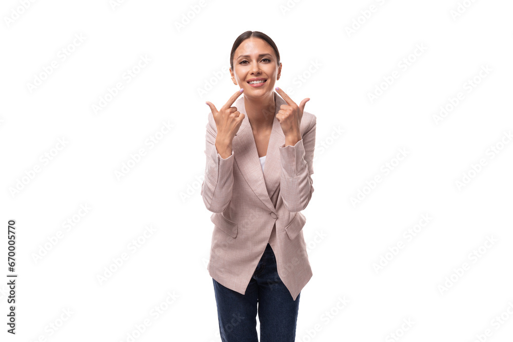 young beautiful brunette with a smooth hairstyle is dressed in a light jacket on a white background with copy space young beautiful brunette with a smooth hairstyle is dressed in a light jacket on a white background with copy space
