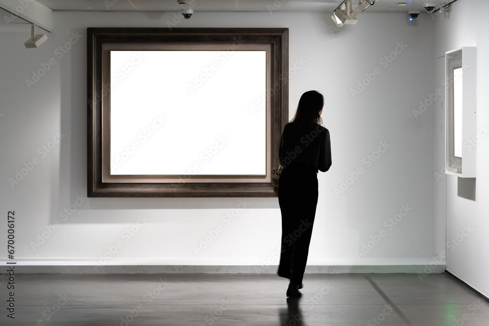 Audiences looking at oil paintings in gallery Audiences looking at oil paintings in gallery