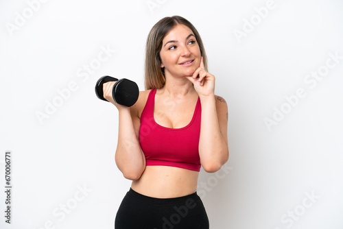 Young sport Rumanian woman making weightlifting isolated on white background thinking an idea while looking up