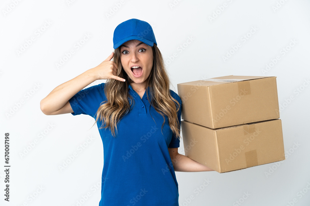 Young Romanian delivery woman isolates on white background making phone gesture. Call me back sign Young Romanian delivery woman isolates on white background making phone gesture. Call me back sign