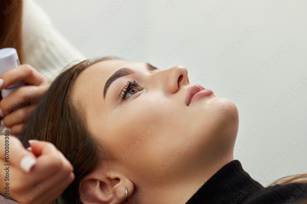 Fototapeta premium eyelash extension procedure. beautiful woman in salon