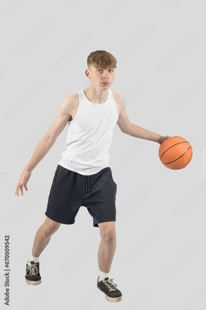 Teenage boy playing basketball Teenage boy playing basketball
