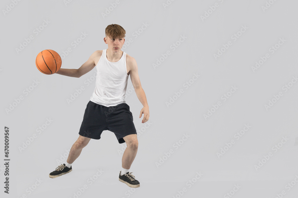 Teenage boy playing basketball Teenage boy playing basketball