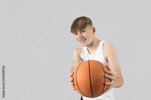 Teenage boy playing basketball