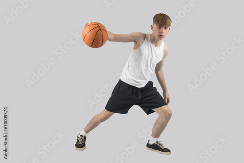 Teenage boy playing basketball © Ben Gingell