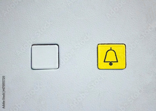 Two elevator buttons with an empty one and alarm