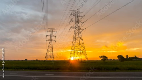 4k time lapse of sunset with transmission electricity steel pylon tower. Green energy sustainability and renewable concept. 
