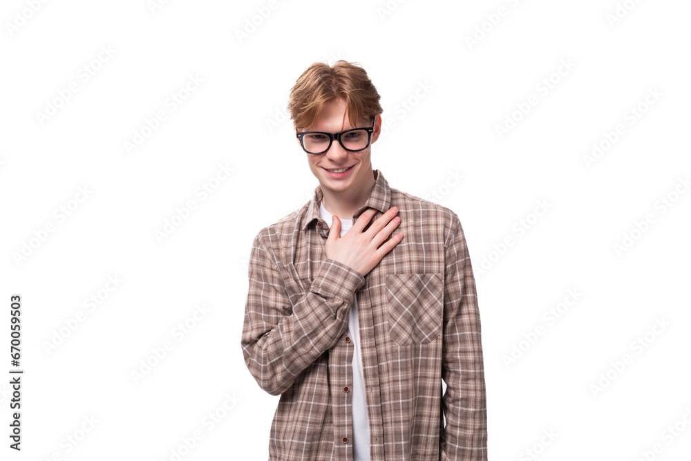 young caucasian man with red hair wears glasses and a shirt