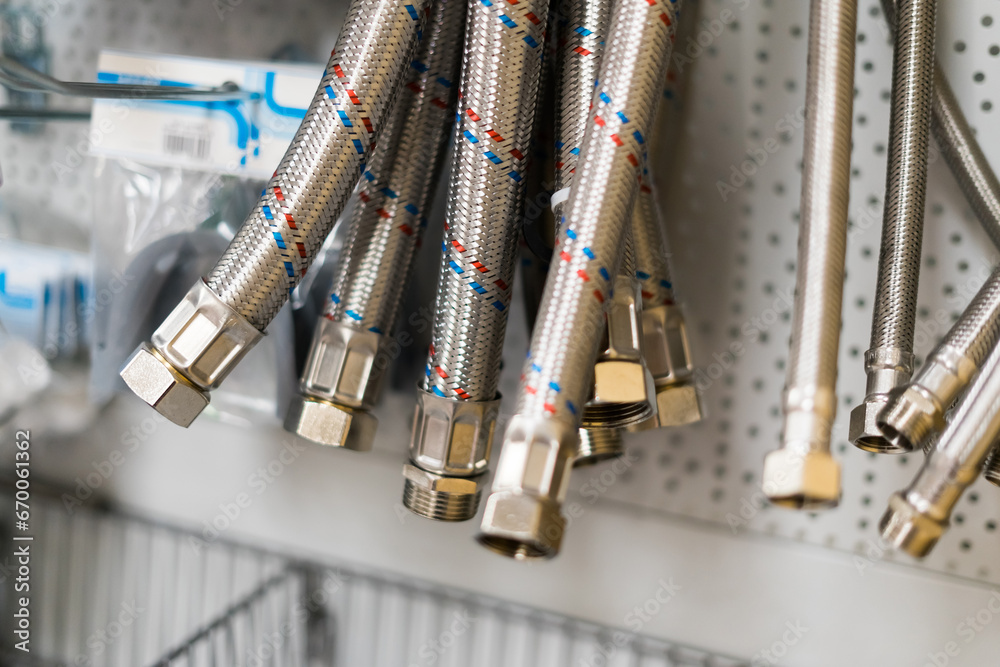 Φωτογραφία Closed up braided stainless steel texture of flexible hose arranged in a row against white wall
