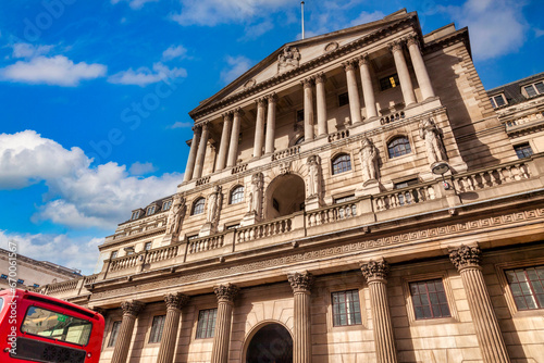 Bank of England, Threadneedle Street, London, UK, with a red London bus passing. photo