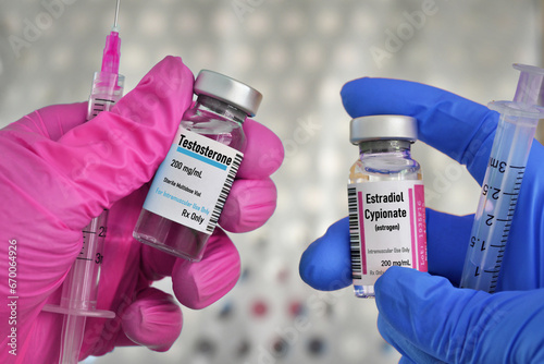 Transgender hormone therapy injections concept - vials of testosterone male and estrogen aka estradiol cypionate female hormones for treatment photo