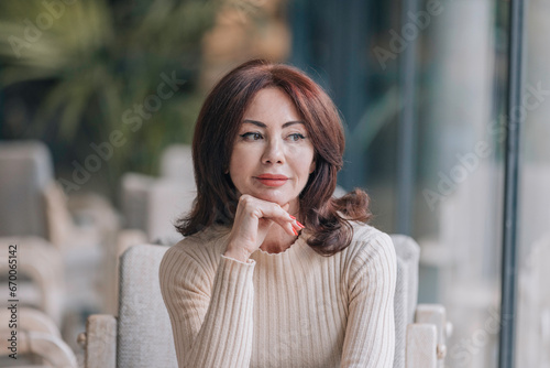 Thoughtful woman looking to the side with a slight smile.